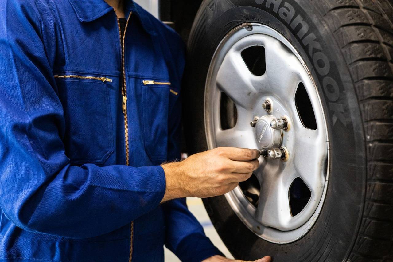 A mechanic mounting a tire on a wheel